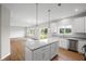 Kitchen with island bar top and stainless appliances overlooking backyard at 107 Cherry Glen Way, Euharlee, GA 30145
