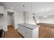 Open kitchen featuring an island with granite countertops, stainless appliances, and hardwood floors at 107 Cherry Glen Way, Euharlee, GA 30145