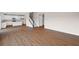 Open-concept living space featuring hardwood floors and a bright white kitchen with granite countertops at 107 Cherry Glen Way, Euharlee, GA 30145