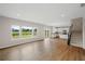 Bright living room with hardwood floors, large windows offering views, and an open layout to the kitchen at 107 Cherry Glen Way, Euharlee, GA 30145