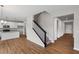 Open-concept living area showcases wood floors, a modern kitchen, and staircase at 107 Cherry Glen Way, Euharlee, GA 30145