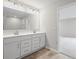 Spacious main bathroom features a double vanity with large mirror and modern lighting at 107 Cherry Glen Way, Euharlee, GA 30145
