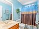 Bathroom featuring a blue accent wall, a toilet, a mirror, and a vanity at 224 Prominent Loop, Mcdonough, GA 30253