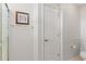 Bright bathroom featuring glass shower doors, white trim, and a toilet at 224 Prominent Loop, Mcdonough, GA 30253