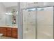 Bathroom showcasing double sinks, a wooden vanity, a large mirror with accent lighting, and glass shower at 224 Prominent Loop, Mcdonough, GA 30253
