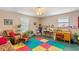 Bright bonus room with natural light, colorful play mats, and work spaces at 224 Prominent Loop, Mcdonough, GA 30253