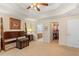 Spacious main bedroom featuring a tray ceiling, a four-poster bed, and ensuite bathroom with a walk-in closet at 224 Prominent Loop, Mcdonough, GA 30253