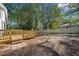 Large backyard featuring a wooden deck, green grass, and a privacy fence at 2442 Connally Dr, East Point, GA 30344