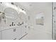 Bathroom boasts double sinks, round mirrors, and white marble accents at 2442 Connally Dr, East Point, GA 30344