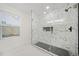 Modern bathroom with glass enclosed shower and marble wall paneling at 2442 Connally Dr, East Point, GA 30344