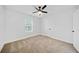 Bedroom with neutral carpet features a ceiling fan and natural light at 2442 Connally Dr, East Point, GA 30344