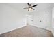 Neutral bedroom showcasing a ceiling fan, carpeting, white walls, and two doors at 2442 Connally Dr, East Point, GA 30344