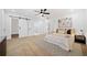 Well-lit bedroom with a barn door, connected bath, and minimalist decor at 2442 Connally Dr, East Point, GA 30344