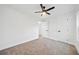 Bright bedroom features a ceiling fan, neutral carpet, and white walls at 2442 Connally Dr, East Point, GA 30344