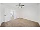 Cozy bedroom with neutral carpeting, a ceiling fan, and a view into kitchen at 2442 Connally Dr, East Point, GA 30344