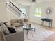 Comfortable living room showcasing modern decor and natural light, with a view of the staircase at 2442 Connally Dr, East Point, GA 30344
