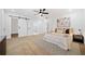 Large main bedroom featuring neutral walls, a decorative headboard, and a view into the attached bathroom at 2442 Connally Dr, East Point, GA 30344