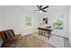 Bright office space with natural light, modern desk, ceiling fan, and cozy chair is ideal for remote work at 2442 Connally Dr, East Point, GA 30344