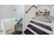 Staircase featuring wooden steps, white risers, a black railing, and an upper level seating area at 2442 Connally Dr, East Point, GA 30344