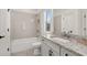 Bright bathroom featuring a shower and tub combination, granite counters and modern fixtures at 5247 Flannery Chase Sw, Powder Springs, GA 30127
