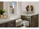 Bathroom featuring double vanity, dark wood cabinets, quartz countertops, and decorative accents at 5247 Flannery Chase Sw, Powder Springs, GA 30127