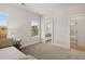 A bedroom featuring carpeted floors, two windows and a connecting door to the bathroom at 5247 Flannery Chase Sw, Powder Springs, GA 30127