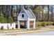 Community amenity structure with white brick, a distinctive round window, and charming Gathering silhouette at 5247 Flannery Chase Sw, Powder Springs, GA 30127