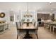 Open dining room featuring a modern chandelier and a view into the gourmet kitchen at 5247 Flannery Chase Sw, Powder Springs, GA 30127
