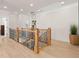 Hallway with wood floors, iron railing, white trim, and recessed lighting at 5247 Flannery Chase Sw, Powder Springs, GA 30127