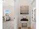 Bright hallway featuring neutral paint, an accent table with decor, and an open doorway at 5247 Flannery Chase Sw, Powder Springs, GA 30127