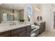 Bright bathroom featuring a double vanity with a large mirror, soaking tub, and a walk-in shower at 5247 Flannery Chase Sw, Powder Springs, GA 30127