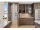 Butler's pantry with glass front cabinets and access to a walk-in pantry with custom shelving at 5247 Flannery Chase Sw, Powder Springs, GA 30127