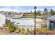 Community pool and splash pad surrounded by colorful flowers in a well-maintained neighborhood at 5247 Flannery Chase Sw, Powder Springs, GA 30127