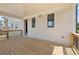 Covered porch with wood flooring, neutral siding, and space for seating and entertaining at 5247 Flannery Chase Sw, Powder Springs, GA 30127