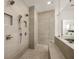 Walk-in shower featuring neutral tile, mosaic floor, and glass partition at 5247 Flannery Chase Sw, Powder Springs, GA 30127