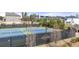 Well maintained tennis courts for the Kyle Farm community with fences and dark netting at 5247 Flannery Chase Sw, Powder Springs, GA 30127
