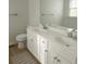 Clean bathroom with double sinks, white cabinets, and a large mirror at 5602 Ardmore Ct, Sugar Hill, GA 30518