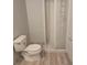 Basic bathroom with a toilet, a shower stall, and neutral walls, offering essential amenities at 5602 Ardmore Ct, Sugar Hill, GA 30518