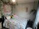 Charming bedroom featuring floral bedding, whimsical wall art, and natural accents throughout the room at 5602 Ardmore Ct, Sugar Hill, GA 30518