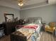 Bright bedroom with a bed, wood floors, dresser, and a comfortable sitting chair at 5602 Ardmore Ct, Sugar Hill, GA 30518