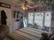 Cozy bedroom with plush bedding, playful decor, and bright natural light shining through the window at 5602 Ardmore Ct, Sugar Hill, GA 30518