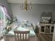 Elegant dining room with a chandelier, seating for eight, and natural light at 5602 Ardmore Ct, Sugar Hill, GA 30518