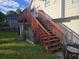 Exterior staircase leads to a small porch, all attached to home at 5602 Ardmore Ct, Sugar Hill, GA 30518