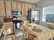 Functional kitchen with stainless steel appliances, light wood cabinets, and a central island with seating at 5602 Ardmore Ct, Sugar Hill, GA 30518