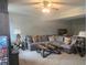 Comfortable living room featuring a large sectional, a wooden coffee table, and cozy decorative pillows at 5602 Ardmore Ct, Sugar Hill, GA 30518