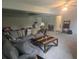 Spacious living room with a plush sectional sofa, a custom coffee table, and ample seating for gatherings at 5602 Ardmore Ct, Sugar Hill, GA 30518