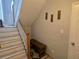 Entryway staircase with a wooden bench, coat hooks, and natural light, creating a welcoming space at 5602 Ardmore Ct, Sugar Hill, GA 30518