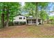 Exterior view of the house from the backyard; wooden fence borders the property at 671 Shannon Green Sw Cir, Mableton, GA 30126