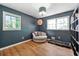 Bedroom featuring hardwood floors, light fixture, and 2 windows with views at 671 Shannon Green Sw Cir, Mableton, GA 30126