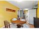 Cozy eat-in kitchen features a rustic wood table, large window, and stainless steel refrigerator at 671 Shannon Green Sw Cir, Mableton, GA 30126